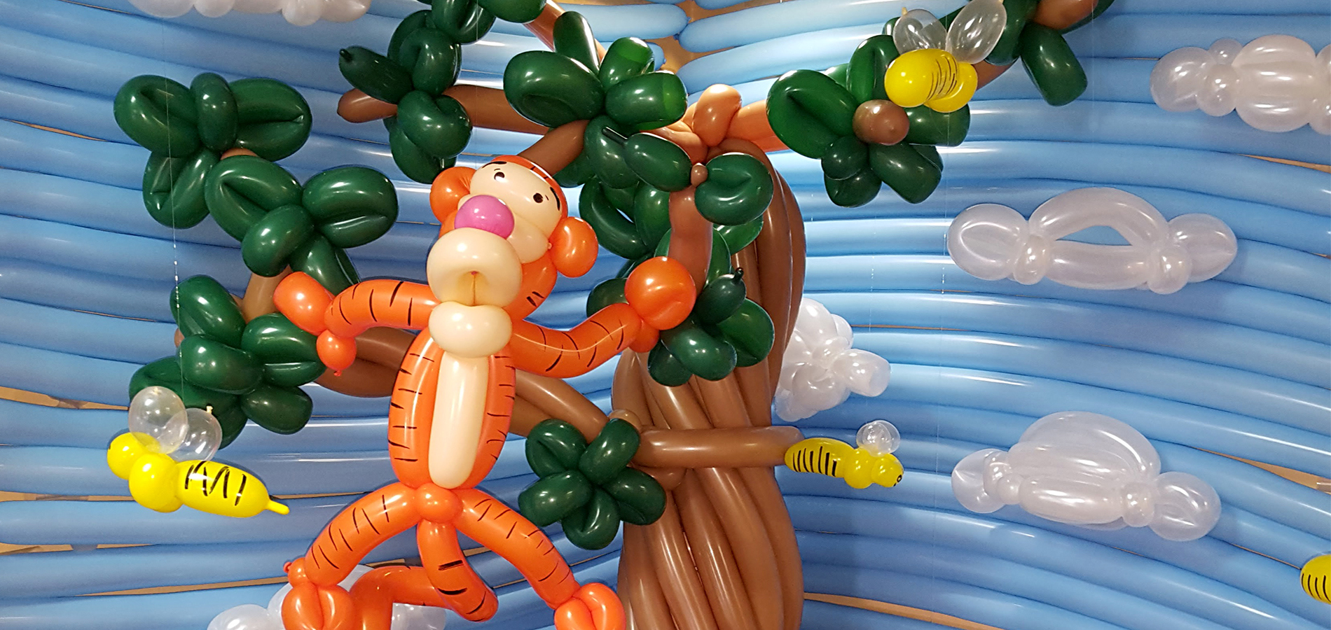 Balloon Twister with balloon dogs in background banner