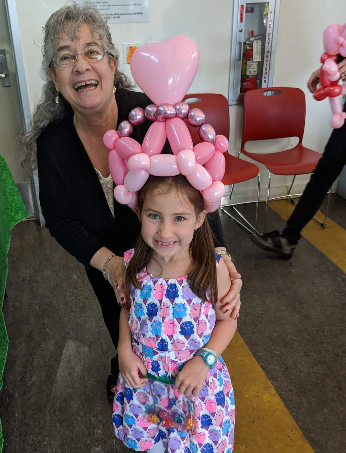 small girl with crown balloon